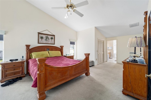 carpeted bedroom featuring ceiling fan, ensuite bath, high vaulted ceiling, and a closet