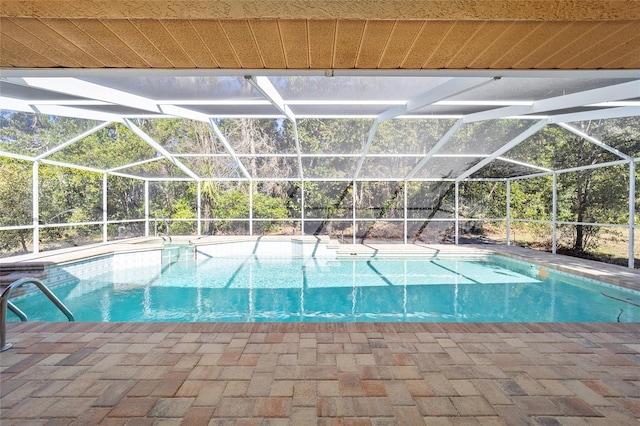 view of swimming pool with a patio and glass enclosure