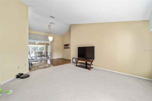 carpeted living room with lofted ceiling