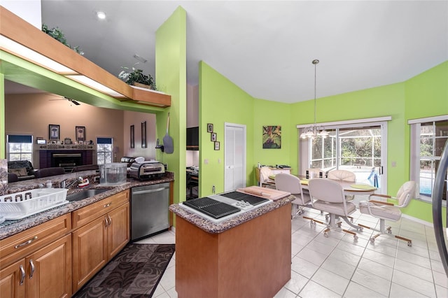 kitchen featuring light tile patterned flooring, pendant lighting, dishwasher, lofted ceiling, and a center island