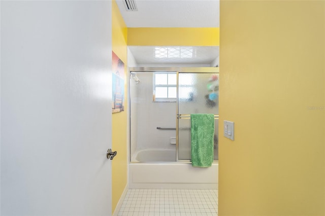 bathroom with tile patterned floors and combined bath / shower with glass door