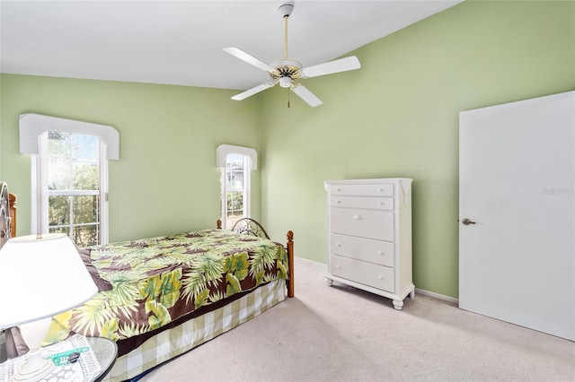 bedroom featuring light carpet, vaulted ceiling, and ceiling fan