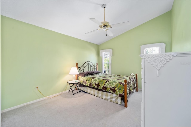 bedroom featuring lofted ceiling, light colored carpet, and ceiling fan