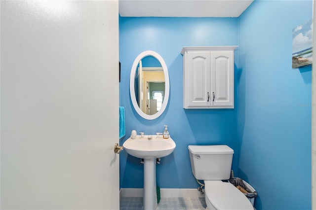 bathroom featuring toilet and tile patterned flooring