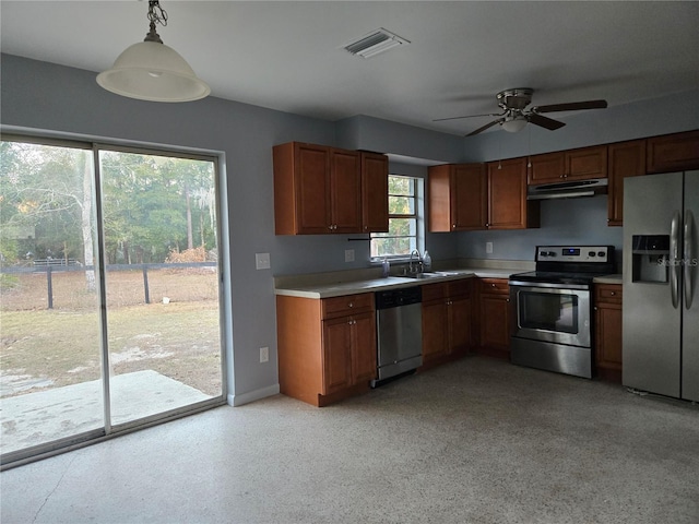 kitchen featuring decorative light fixtures, plenty of natural light, stainless steel appliances, and ceiling fan