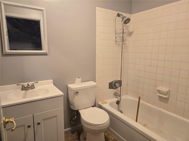 full bathroom featuring toilet, tiled shower / bath, and vanity