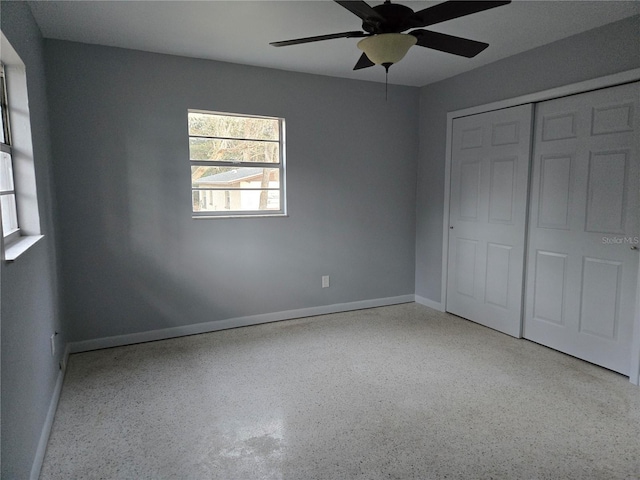 unfurnished bedroom with ceiling fan and a closet