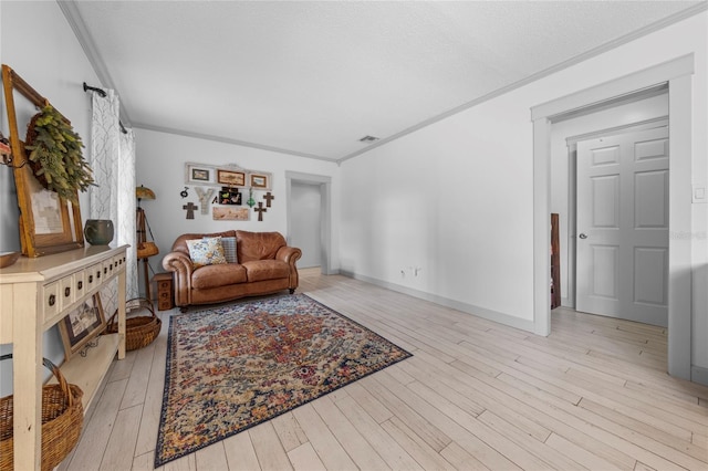 living room featuring ornamental molding and light wood-type flooring