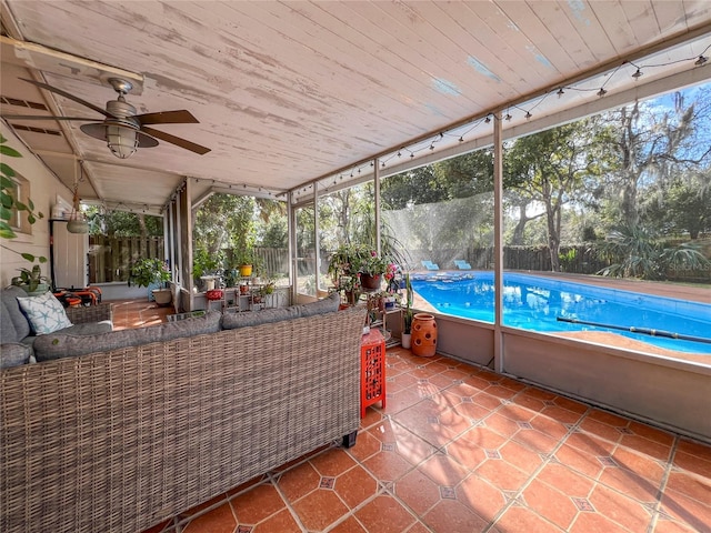 unfurnished sunroom featuring ceiling fan and wood ceiling