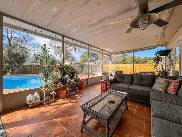 sunroom / solarium featuring ceiling fan and wooden ceiling