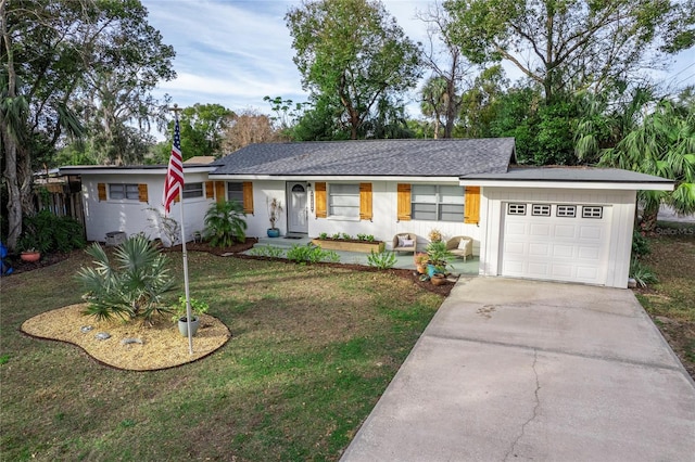 ranch-style house featuring a front yard and a garage