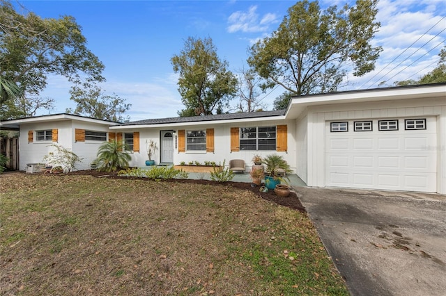 ranch-style house with a garage and a front yard