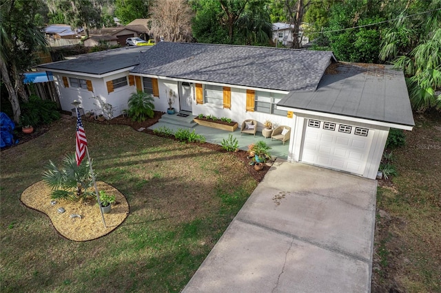 ranch-style house with a garage and a front yard