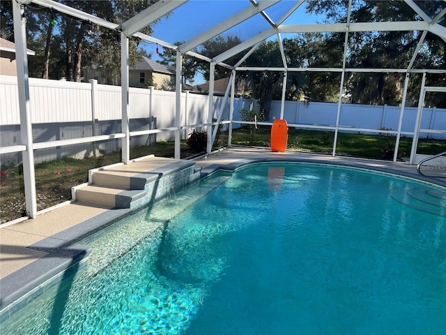 view of pool featuring glass enclosure