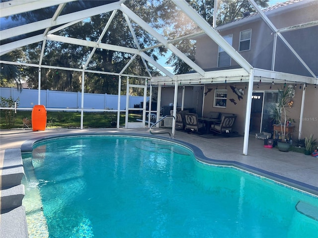 view of pool featuring a patio and glass enclosure