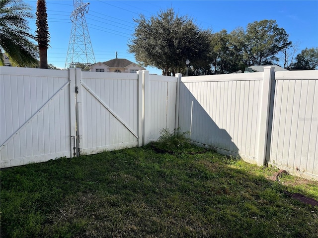 view of gate featuring a yard