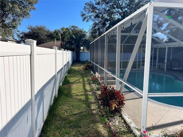 view of yard with glass enclosure