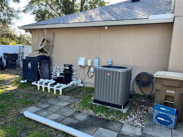 view of side of home featuring central AC