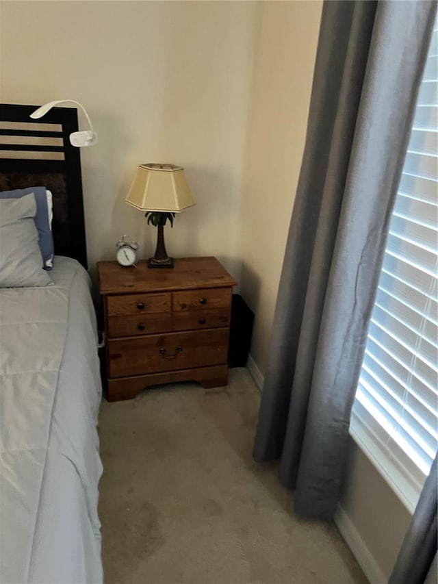 bedroom featuring light colored carpet