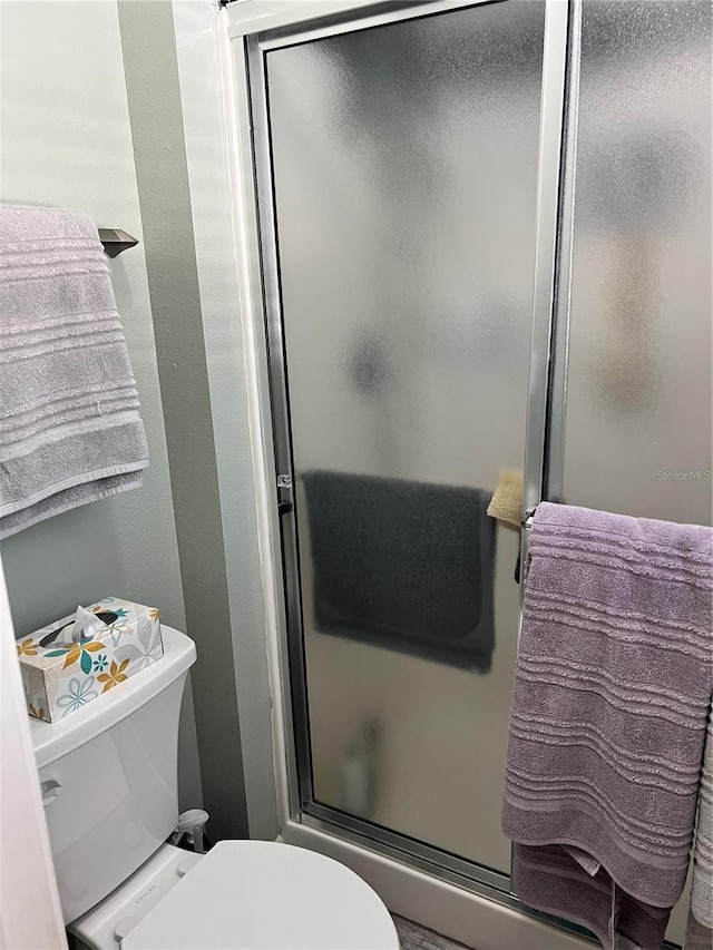 bathroom with walk in shower and toilet