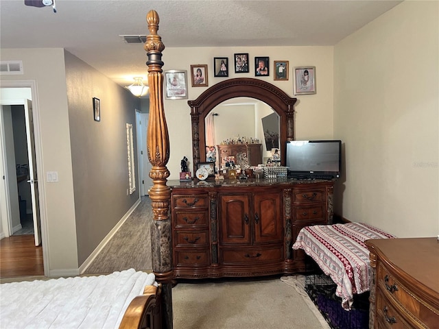 carpeted bedroom featuring a textured ceiling