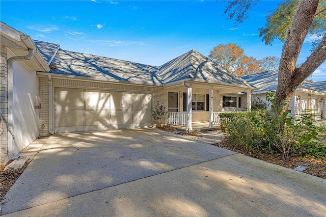 view of front of property featuring covered porch and a garage