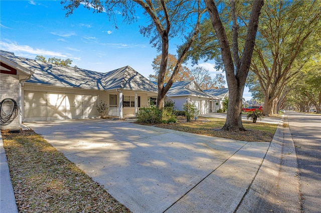 view of front of property featuring covered porch and a garage