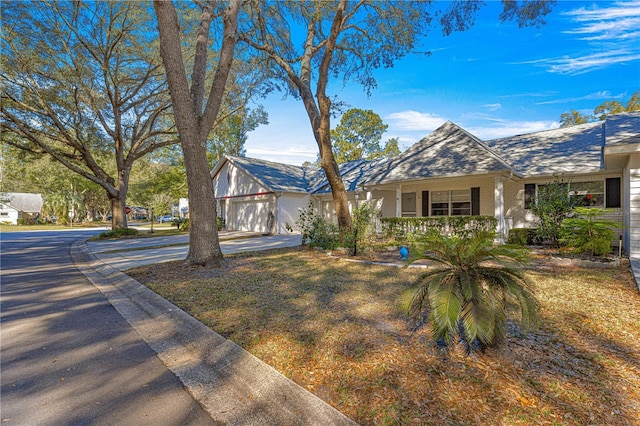 ranch-style house with a garage and a porch