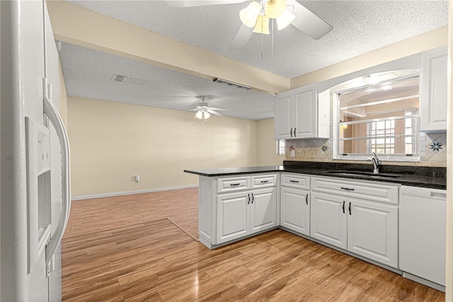 kitchen featuring white cabinetry, sink, white appliances, and tasteful backsplash