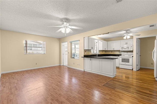 kitchen with white cabinetry, white appliances, decorative backsplash, and light wood-type flooring