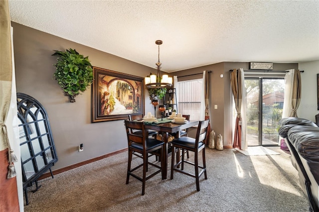 dining space featuring carpet floors, a textured ceiling, and an inviting chandelier