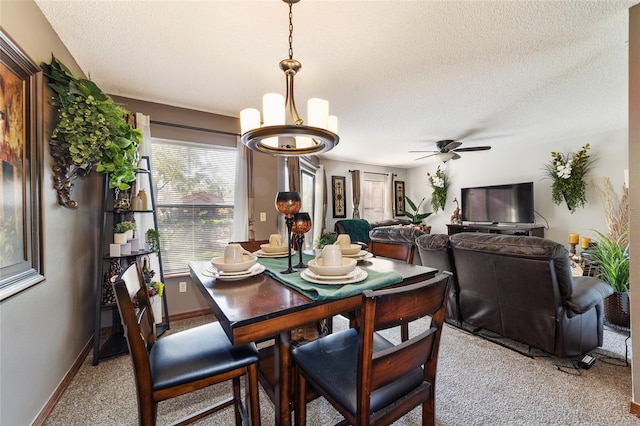 dining room featuring ceiling fan, a textured ceiling, and carpet flooring