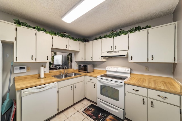 kitchen with a textured ceiling, sink, white cabinets, and white appliances