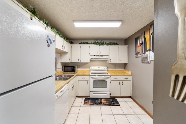 kitchen with white appliances, a textured ceiling, white cabinetry, sink, and light tile patterned flooring