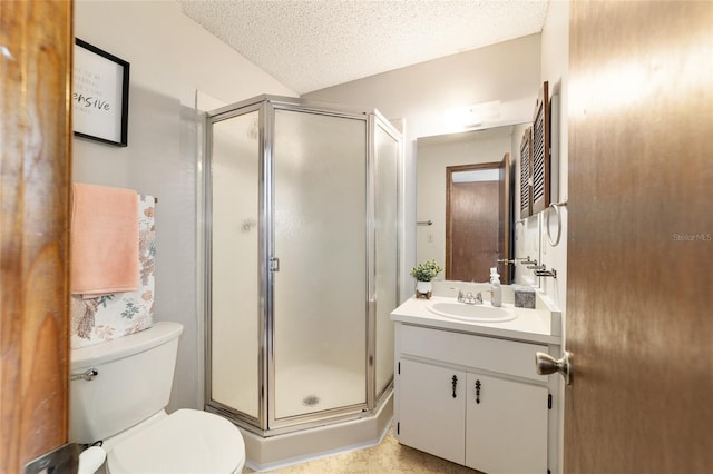 bathroom with a textured ceiling, walk in shower, vanity, and toilet