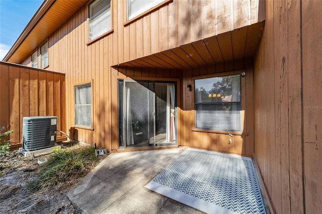 entrance to property featuring cooling unit and a patio