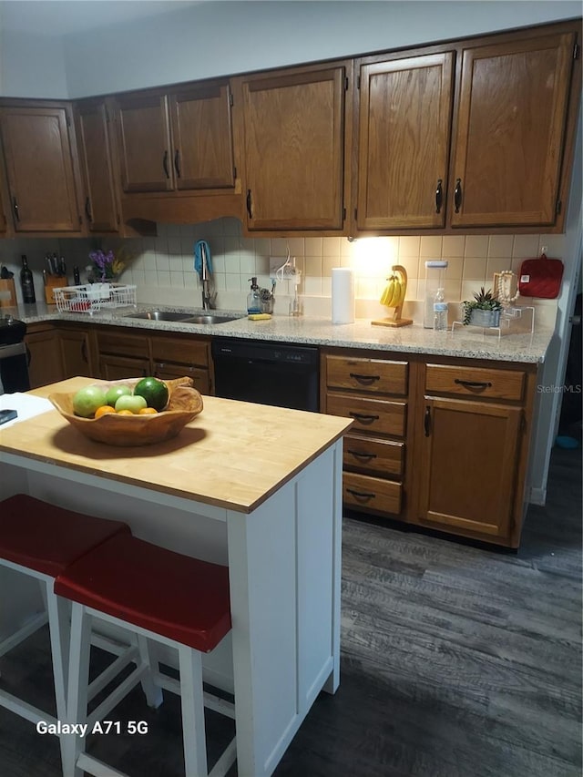 kitchen featuring dark hardwood / wood-style flooring, dishwasher, backsplash, and sink