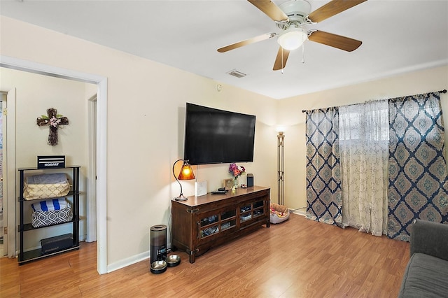 living room with ceiling fan and hardwood / wood-style floors