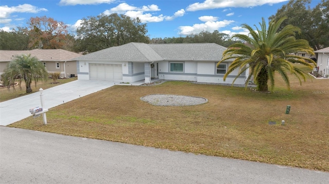 ranch-style home with a garage and a front yard