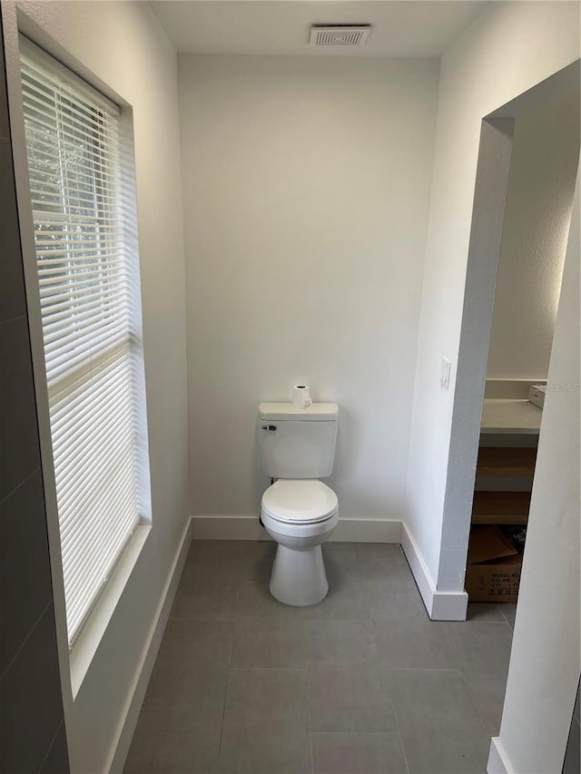 bathroom featuring tile patterned floors and toilet