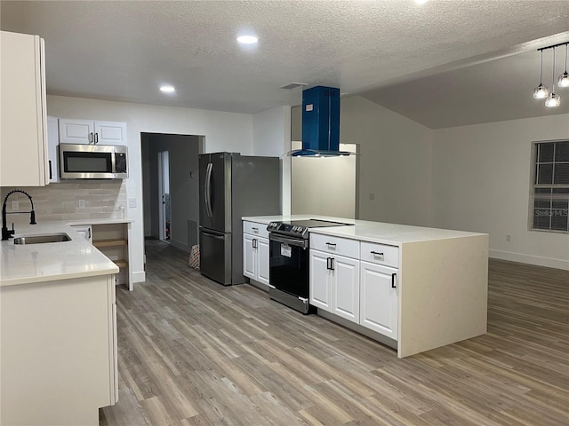 kitchen featuring sink, white cabinetry, hanging light fixtures, appliances with stainless steel finishes, and island exhaust hood