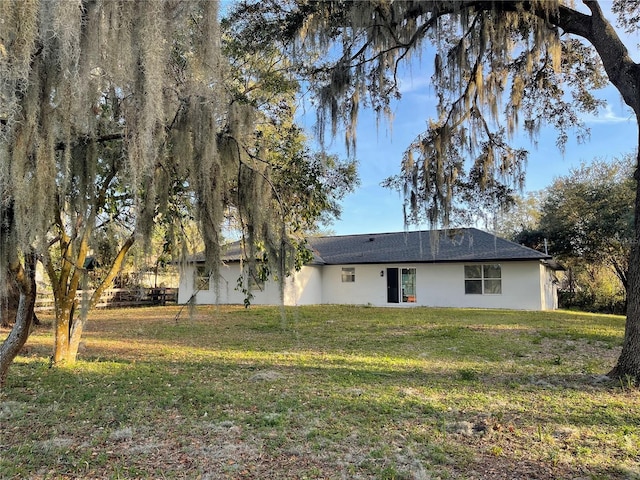 back of house featuring a yard