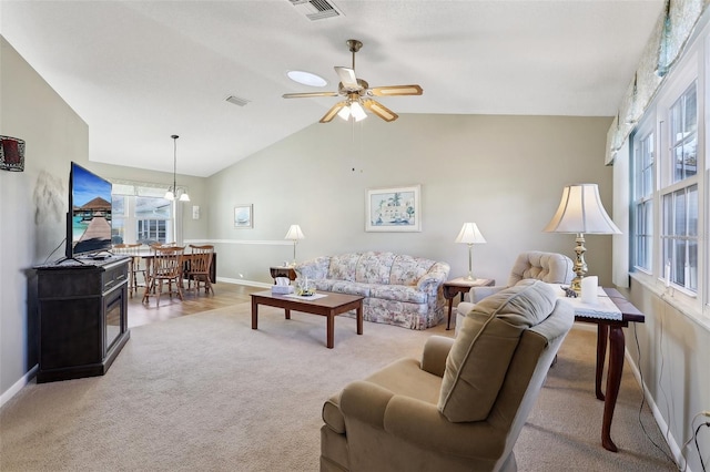 carpeted living area featuring visible vents, baseboards, and lofted ceiling