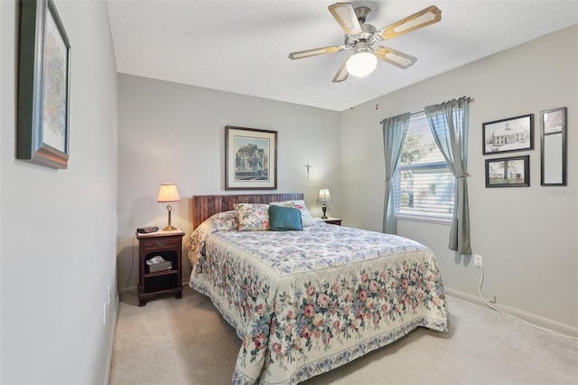 bedroom with a ceiling fan and carpet