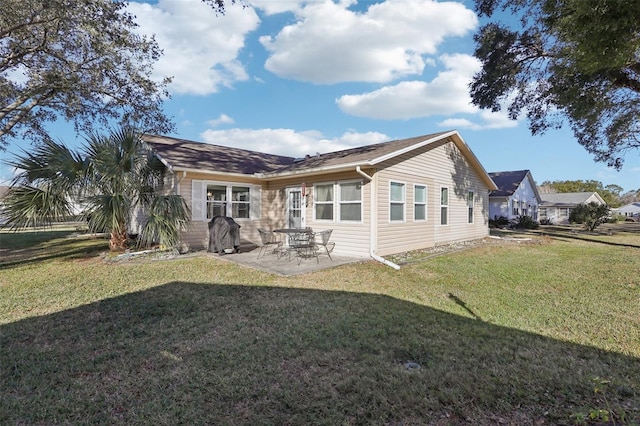 rear view of property featuring a patio area and a yard