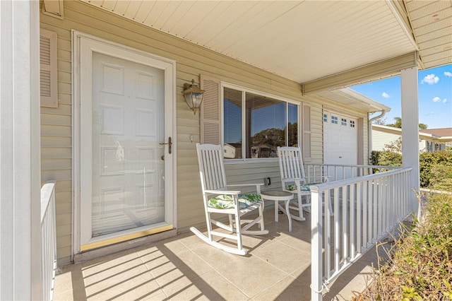 entrance to property with covered porch and a garage