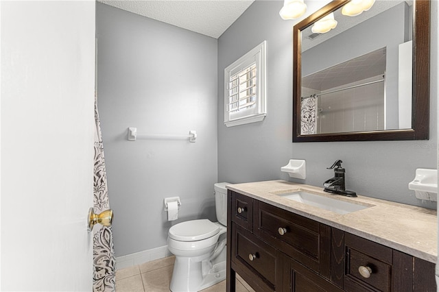 bathroom featuring toilet, a textured ceiling, curtained shower, tile patterned flooring, and vanity