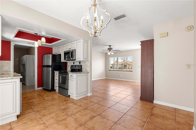 kitchen with backsplash, pendant lighting, white cabinets, and stainless steel appliances