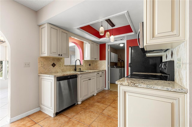 kitchen with a raised ceiling, decorative light fixtures, sink, appliances with stainless steel finishes, and light tile patterned floors