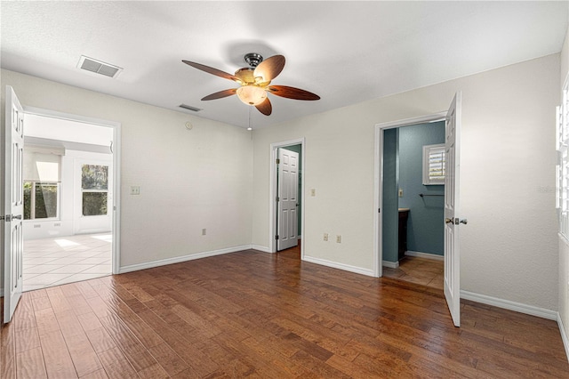 unfurnished bedroom featuring ceiling fan and dark hardwood / wood-style floors